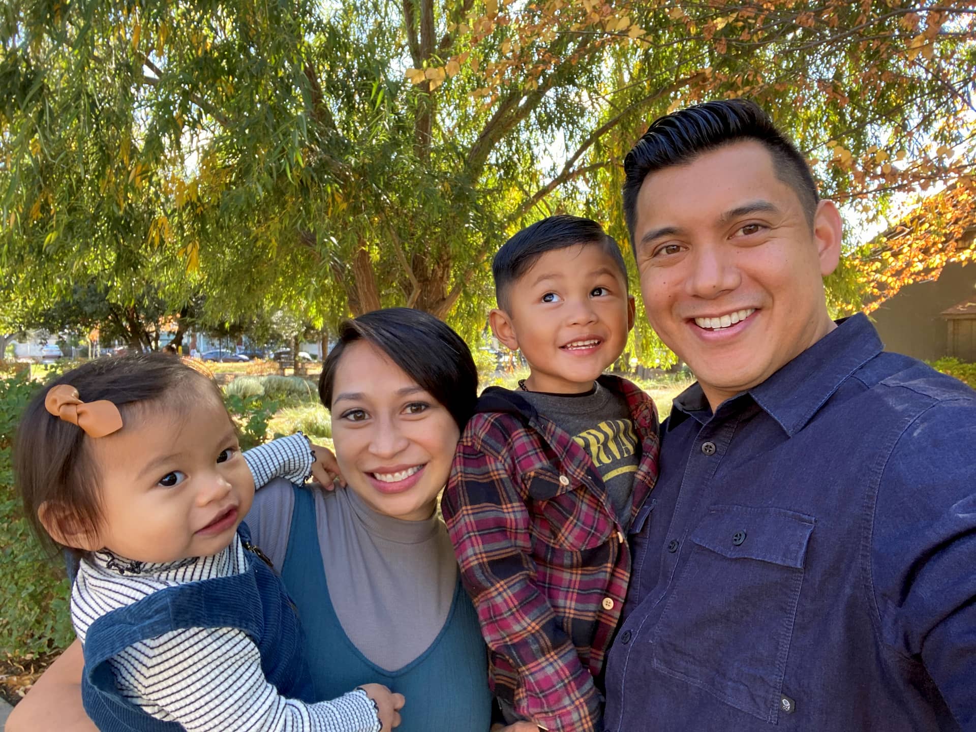 Jourdan Sy posing with his wife and children.